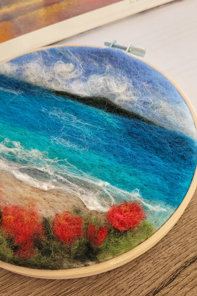 Felted Painting in an Embroidery hoop with a scenic design of a beach and ocean.
