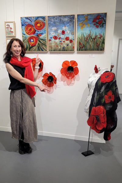 I'm standing in a gallery with floral decorations and artworks on the wall.