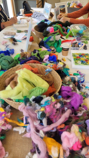 Colourful wools on the workshop table. Creating people during art class.