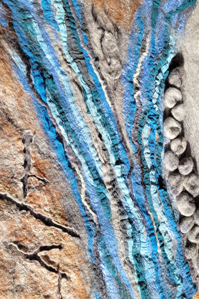 Close-up of layered rock with blue and brown colors
