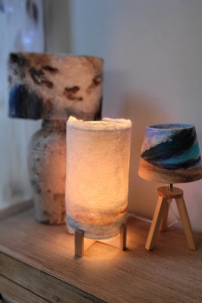 Decorative lamp with stone-like base on a wooden surface