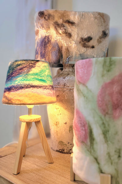 Decorative lamps with unique designs on a wooden surface