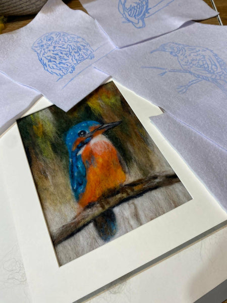 Colorful bird needle painting with white felt templates.