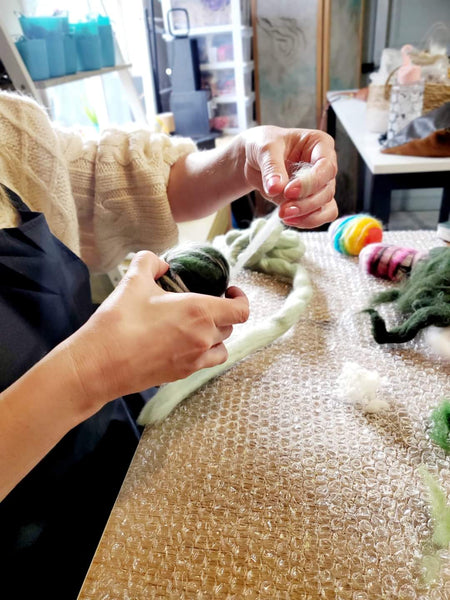Person working with wool and soap, Workshop in the Vesu studio.
