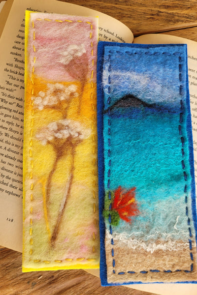 Colorful felt bookmarks on a stack of books with a wooden surface background
