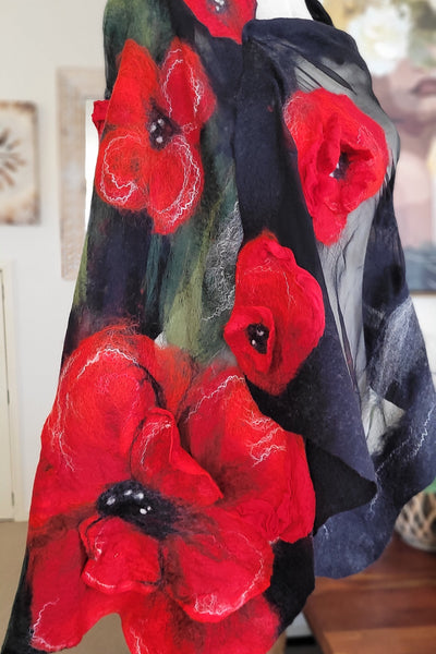 Felted shawl with red poppy flowers on a dark background