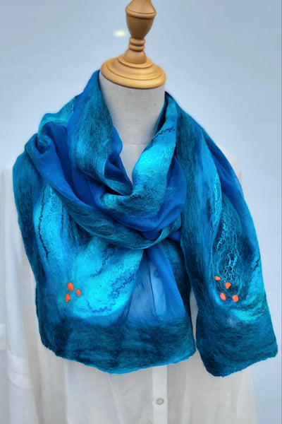 Blue nuno felted scarf on a mannequin against a light gray background