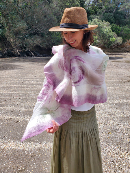 Scarf in soft pastel shades of cream, lavender, and sage green, delicate floral pattern in a romantic, bohemian style.