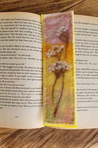 Decorative bookmark with a floral design on an open book