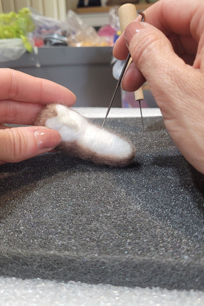 Needle felting owl in an art studio