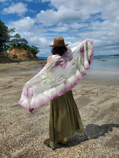 Scarf in soft pastel shades of cream, lavender, and sage green, delicate floral pattern in a romantic, bohemian style.