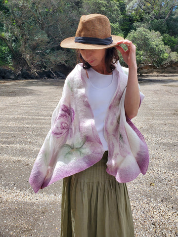 Scarf in soft pastel shades of cream, lavender, and sage green, delicate floral pattern in a romantic, bohemian style.