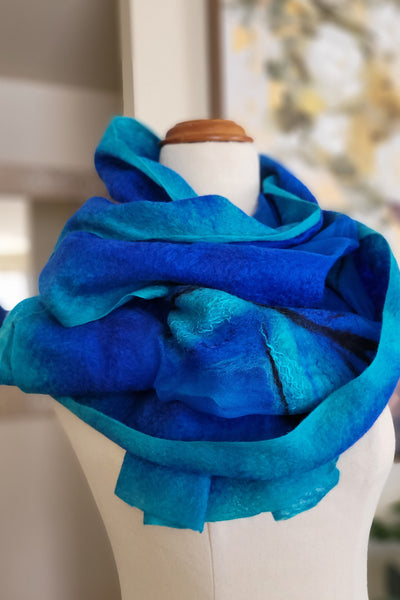 Blue fabric on a mannequin arm with a blurred indoor background