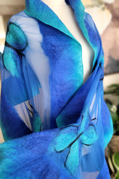 Blue and turquoise butterfly patterned fabric on a mannequin