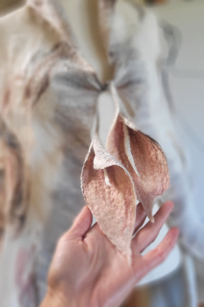 Close-up of a hand holding a piece of bread with a blurred background